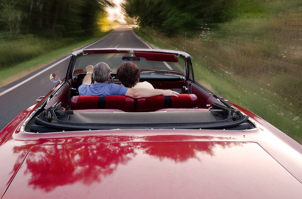 retired couple in convertible