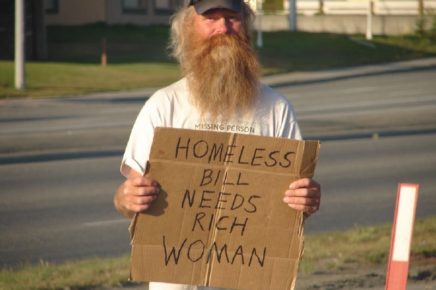 old homeless man with funny sign