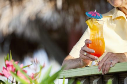 Cropped view of woman holding a tropical drink