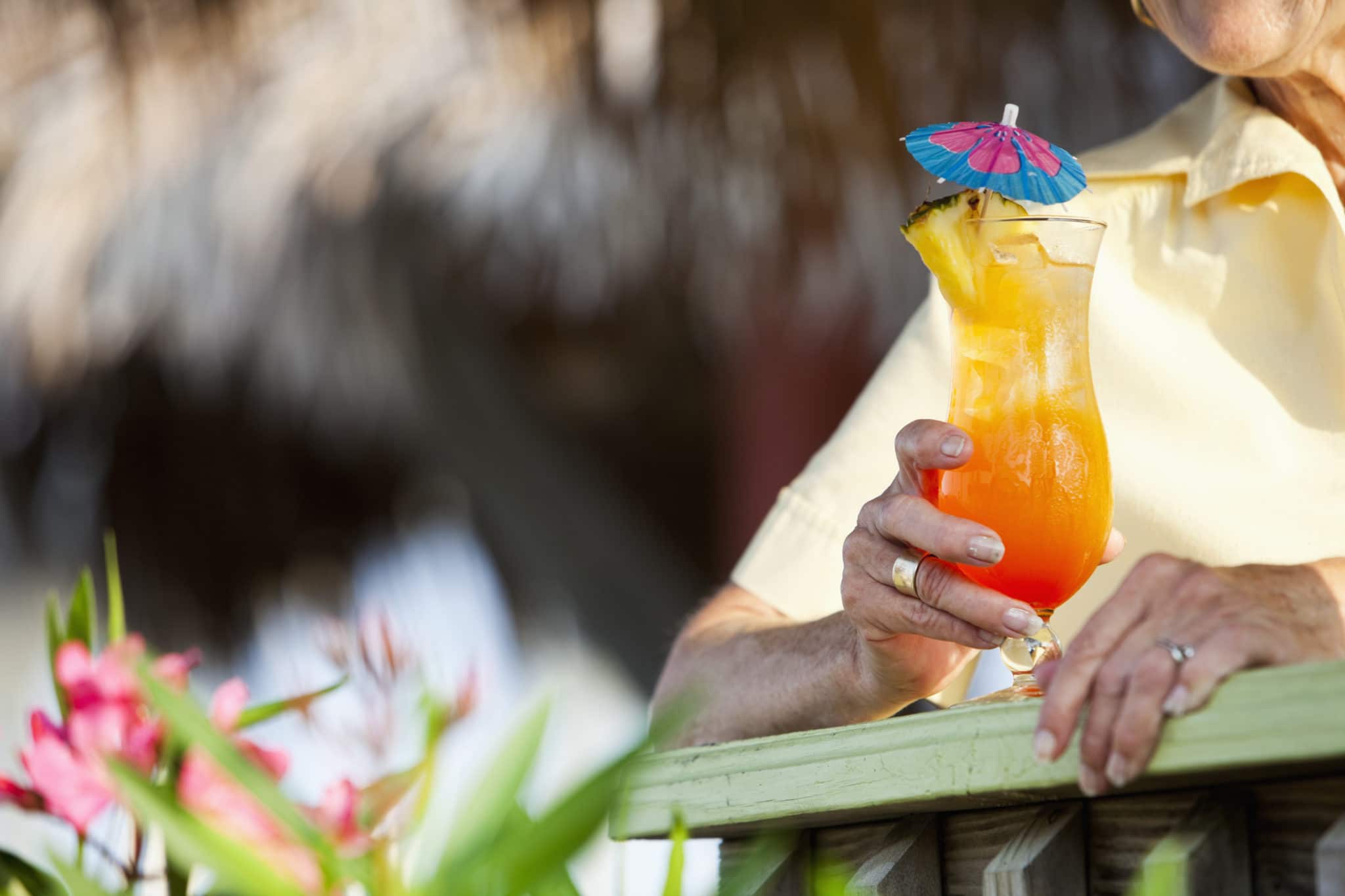 Cropped view of woman holding a tropical drink