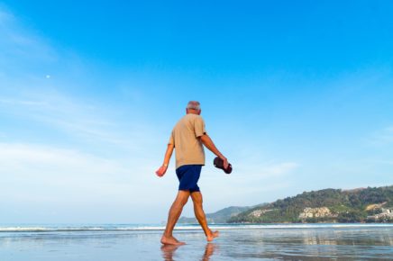 Happy retiree walking on the beach