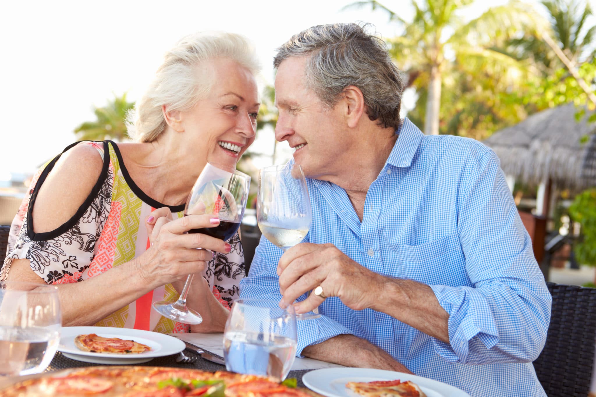 Senior Couple Enjoying Meal In Outdoor Restaurant